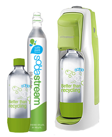 A white and green SodaStream sparkling water maker with a bottle inside, alongside a separate SodaStream carbonator canister and a plastic bottle labelled "Better than recycling.