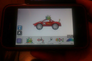 A smartphone screen displays a colourful cartoon car with decorations on its roof and side, surrounded by icons and buttons, suggesting one of the top 10 mobile apps for children focused on drawing and customisation.