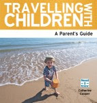 Book cover titled "Travelling With Children: A Parent’s Guide." Below the title, a smiling young child wearing a hat plays with a bucket on a sandy beach—capturing the joy of family travel at the seaside.
