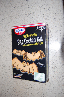 A box of Dr. Oetker Bat Biscuit Kit for Hallowe’en, featuring images of bat-shaped biscuits on a black background with white cobweb illustrations and bold yellow text.