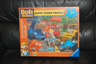 A Bob The Builder Giant Floor Puzzle box features cartoon construction characters on the front. This Ravensburger set includes 24 pieces and is suitable for ages 3 and over, making it a fun giant floor puzzle for young builders.