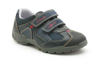 A dark blue and grey children's trainer from Clarks Shoes with white stitching, Velcro straps, and red logo accents. Featuring a rugged rubber sole and padded white interior lining—perfect for any adventure. See our Clarks Shoes review for more details.