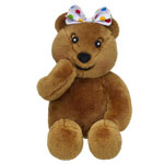 A brown teddy bear with a smiling face, one paw raised to its cheek, and a white bow with colourful polka dots on its head—perfect for supporting children and making memories at Build-A-Bear Workshop.