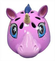 A pink Raskullz unicorn-shaped safety helmet featuring a yellow horn, blue eyes, purple ears and mane, and several ventilation holes. Perfect for any Helmet Review.