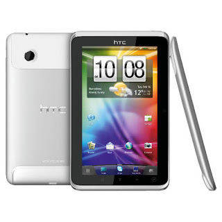 A silver HTC Flyer tablet is displayed from the back, front, and side, showing its camera, logo, and colourful home screen with weather, time, and app icons—perfect for any thorough HTC Flyer review.