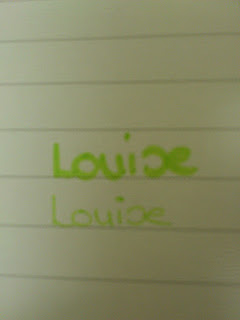 The word "Louise" is written twice in green ink, likely with Stabilo writing products, on lined paper—one above the other; the top writing is bolder than the bottom one.