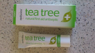 A tube and box of Nelson's tea tree cream labelled "natural first aid antiseptic" on a speckled worktop—one of the First Aid Must-Haves for every Mummy First Aid kit.