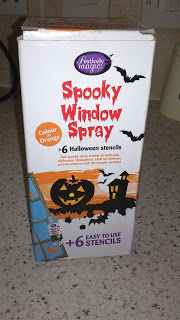 A box of "Spooky Window Spray" from Poundland, featuring bats, a pumpkin, and bold orange Hallowe’en-themed text. The packaging includes 6 easy-to-use stencils for decorating windows with festive flair.