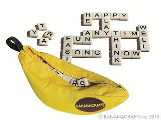A yellow zippered pouch shaped like a banana, labelled "BANANAGRAMS," is open with letter tiles spilling out—perfect for some 12 Days of Christmas fun. Tiles form intersecting words like "PLAY," "TIME," "THINK," and "FUN.