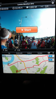 A tablet screen displays a running app for the London Marathon 2012, similar to a Kinomap Trainer review, showing live runners at the start line, a large "Start" button, and a race route map highlighted in red.