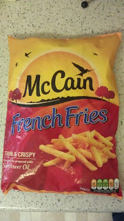 A bag of McCain French Fries featuring an image of chips on the front. The fun yellow and red packaging shows “Thin & Crispy” and “Sunflower Oil” at the bottom—a must-have for every foodie!.