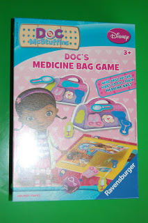 A box of "Doc McStuffins: Doc’s Medicine Bag Game" board game by Ravensburger, featuring cartoon illustrations of Doc McStuffins and toy medical tools, on a green background. For ages 3 and over.