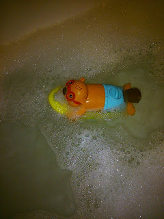 A bath toy in a bubble bath
