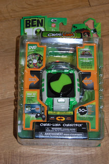 A packaged Ben 10 Omni-Link Omnitrix toys set in its original green and orange blister packaging, featuring the Ben 10 logo, product information, and images of the watch and characters.