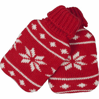 A pair of red knitted mittens with white snowflake and dot patterns, featuring ribbed cuffs—perfect as stocking fillers or a cosy winter pick from Asda.