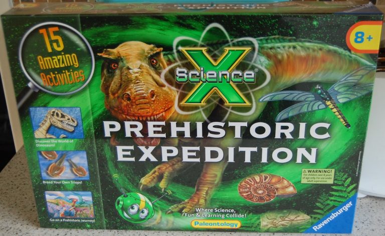 Box for the Ravensburger Science "Prehistoric Expedition Kit," featuring dinosaur, fossil, and prehistoric insect illustrations. It advertises "15 Amazing Activities" and is suitable for ages 8 and over.