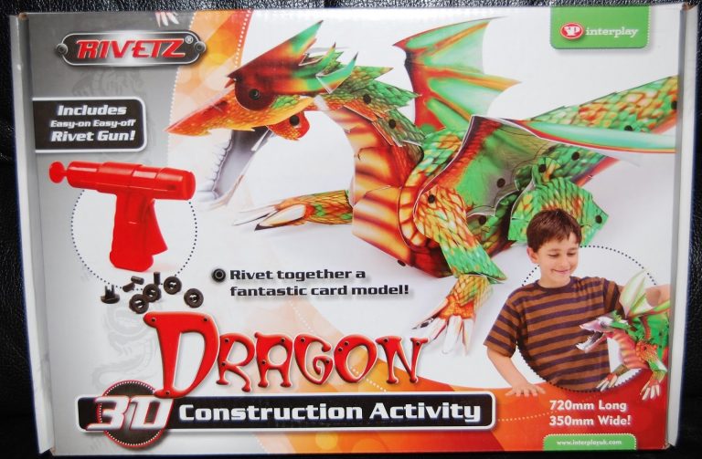 Box for the Technokit Rivetz Dragon 3D Construction Activity kit, showing a green dragon model, a red rivet gun, rivets, and a smiling child holding the dragon. Text highlights kit features, dimensions, and invites you to review your build.