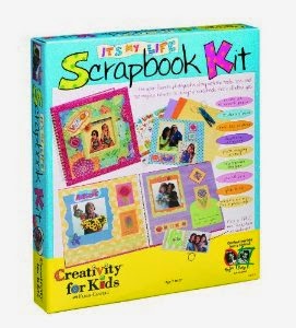 A colourful box labelled "Scrapbook Making Kit" features decorated scrapbook pages with photos and stickers. Text on the box says "Creativity for Kids" and "It's My Life!" Perfect for ages 7 and up—great for any scrapbooking competition!.