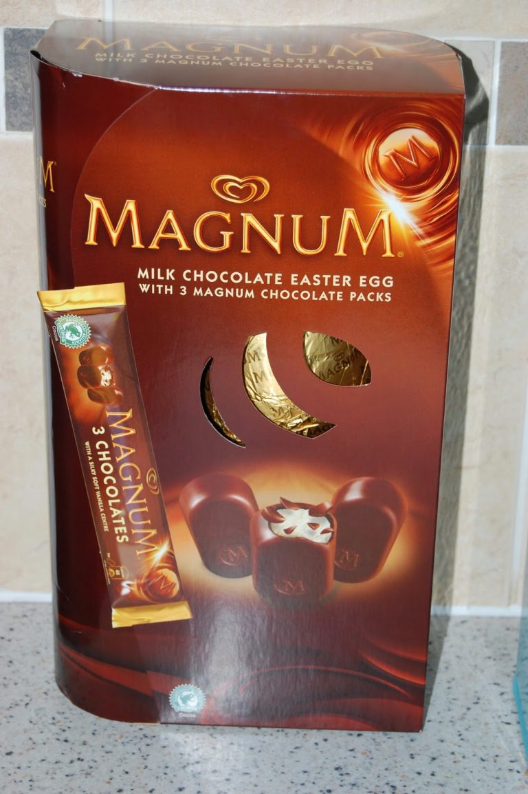 A Magnum Milk Chocolate Easter Egg box with 3 Magnum chocolate packs, featuring an image of the egg and chocolates on the packaging, placed on a kitchen worktop next to a Cornetto ice cream cone.
