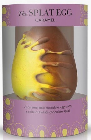 A caramel milk chocolate egg from Hotel Chocolat with a yellow and white chocolate splat design, displayed in purple and yellow packaging labelled "The SPLAT EGG CARAMEL"—a fun twist on classic Easter eggs.
