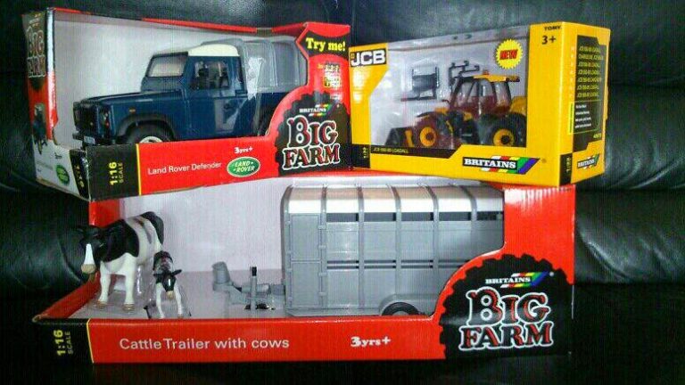 Three boxed Big Farm toys: a blue Land Rover Defender, yellow JCB tractor, and a cattle trailer with two cows and a farmer. All are labelled "Britains Big Farm" and suitable for ages 3 and over.