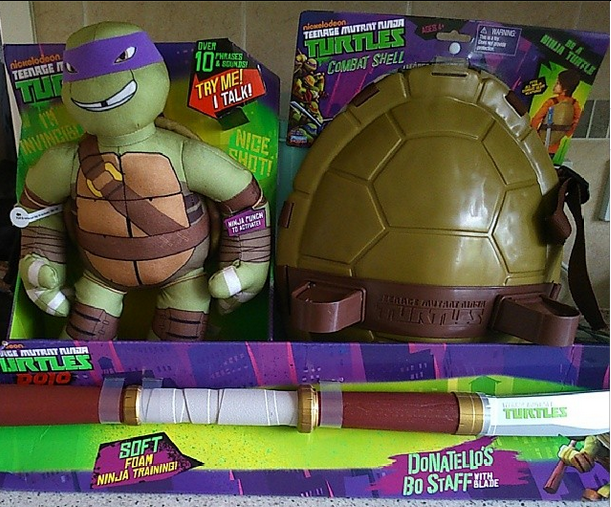 Boxed Ninja Turtles Toys featuring a plush Donatello doll, a plastic turtle combat shell, and Donatello’s foam bo staff, all with vibrant Teenage Mutant Ninja Turtles branded packaging.