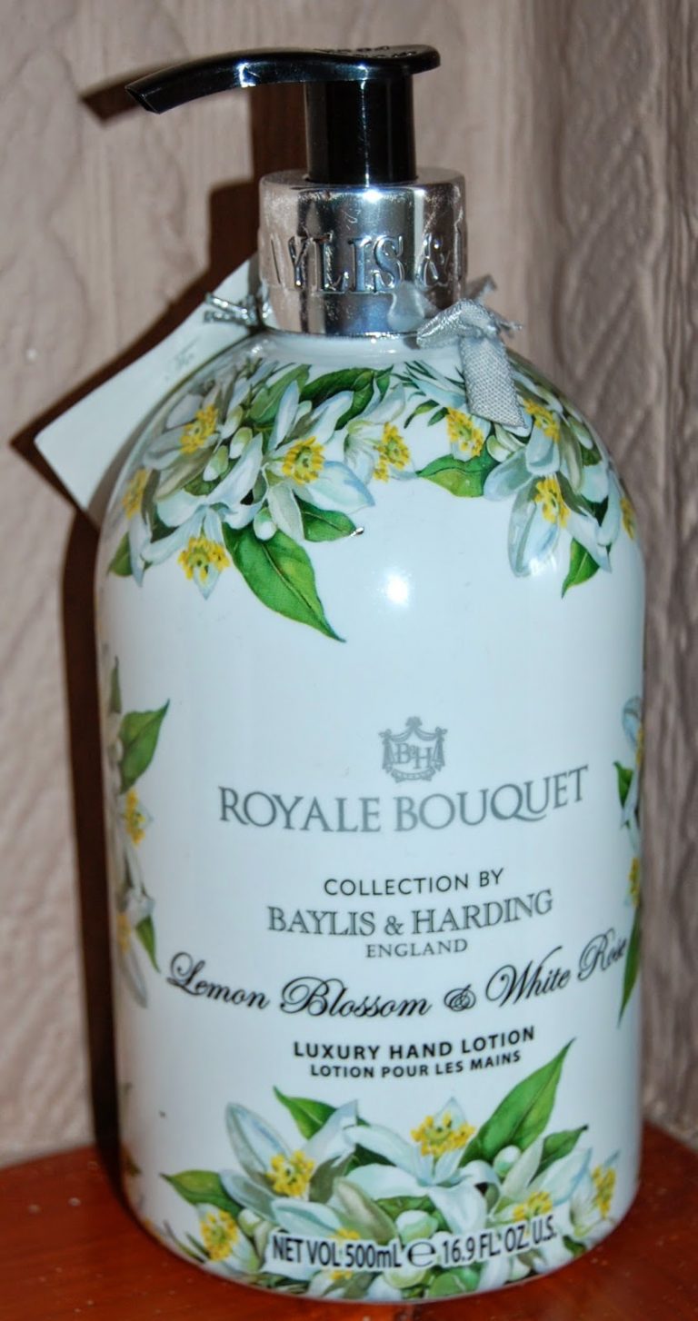 A bottle of Baylis & Harding Royale Bouquet Luxury Hand Lotion in Lemon Blossom & White Rose scent, decorated with white flowers and green leaves—a perfect choice when you want to buy presents for teachers, featuring a silver pump and a grey ribbon.