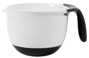 A white mixing bowl with a black non-slip base, a spout for pouring, and a large black handle—an essential OXO Good Grips kitchen tool perfect for your collection of cooking utensils.