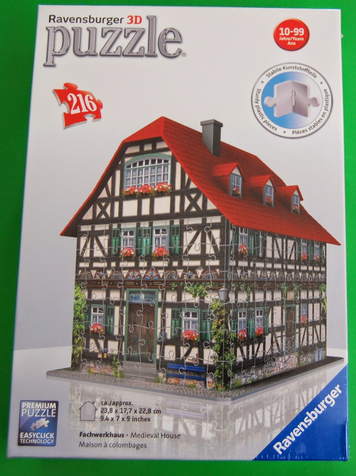 Box for a Ravensburger 3D puzzle featuring a Medieval House with half-timbered walls and a red roof. This 216-piece puzzle is suitable for ages 10–99, with product information in multiple languages on the box.