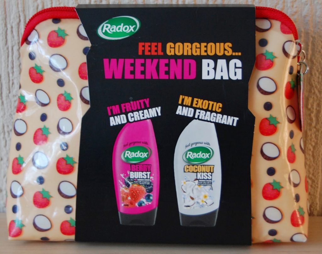 A Radox "Weekend Bag" gift set, perfect among gifts for her, includes a cream toiletry bag with strawberry and cherry designs, plus two shower gels: Berry Burst ("I'm Fruity and Creamy") and Coconut Kiss ("I'm Exotic and Fragrant").