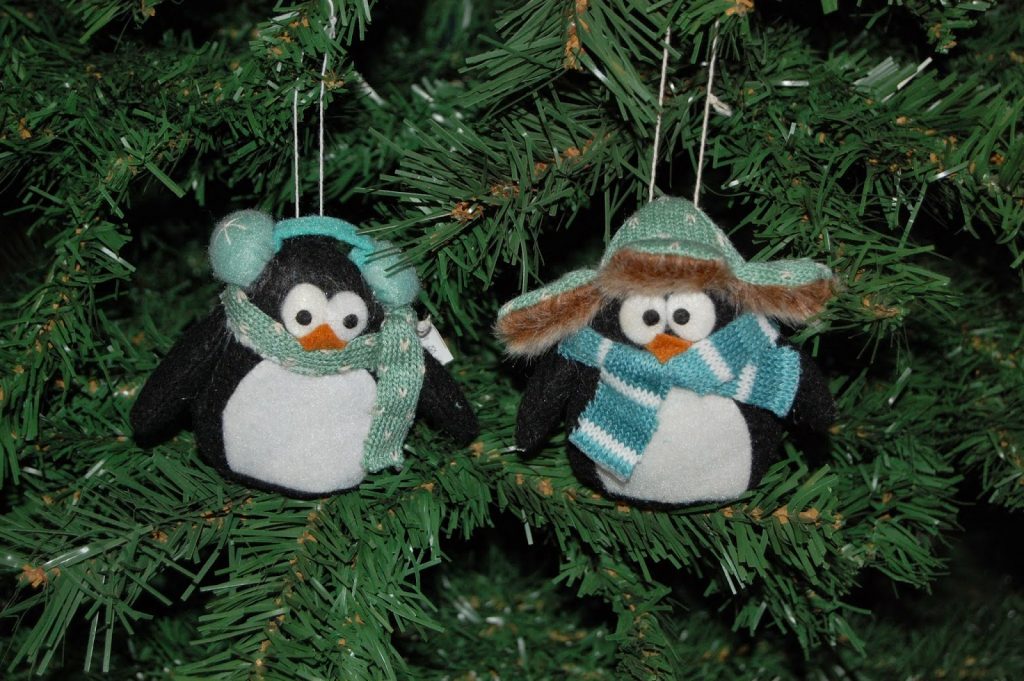 Decking the halls is easy with these charming penguin ornaments, dressed in scarves and winter hats, nestled among the green branches—perfect for adding festive cheer to your holiday decorating and home décor.