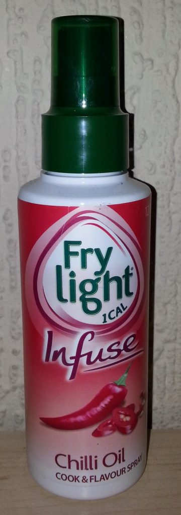 A bottle of Frylight Infuse Chilli Oil cooking spray with a green cap and a red label featuring images of red chilli peppers, as seen in a Degustabox review, placed against a textured beige background.