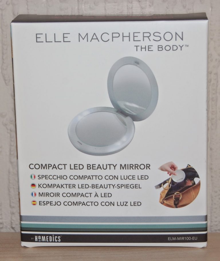A product box for the Elle Macpherson "The Body" Compact LED Beauty Mirror, featuring an image of the open mirror and multilingual descriptions; a hand holds the compact in a small photo—perfect for beauty gifts or Mother’s Day presents.