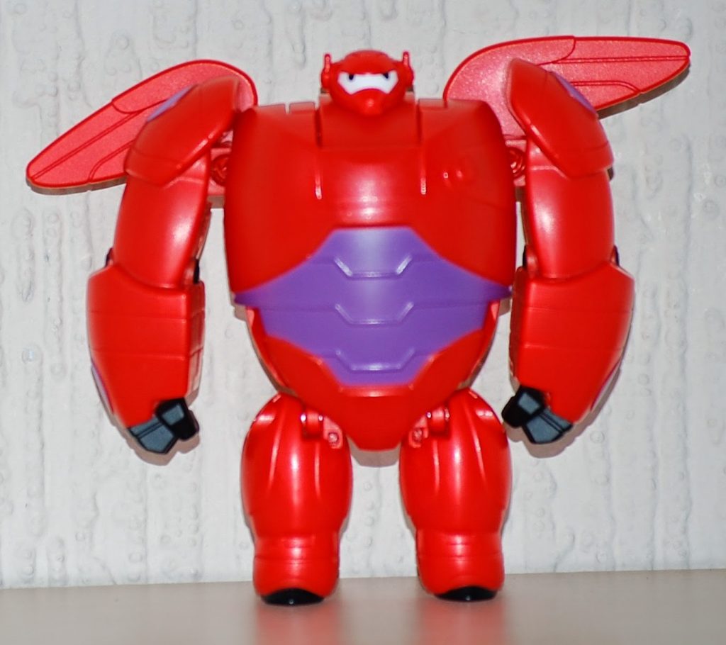 A red and purple robot toy with large arms, black hands, and translucent red wings stands upright against a light-coloured background, making it a fun choice for Alternative Easter Gifts.