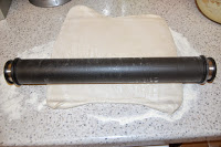 A black rolling pin rests on top of a sheet of pastry spread out on a floured worktop, ready for the Pear Tarte Tatin Challenge inspired by Heston.