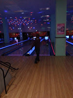 A person walking in a bowling alley during James's 6th birthday celebration.