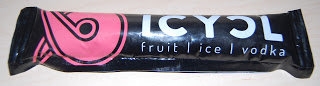 A black ice lolly wrapper labelled "ICYCL" with the words "fruit | ice | vodka" and a pink abstract logo on the left side, featured as part of a snack subscription in a recent Degustabox review, lying on a light-coloured surface.