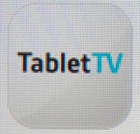 The image displays a rounded square TabletTV logo with "Tablet" in black and "TV" in light blue on a light grey background, perfect for a review or tech feature.