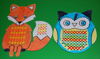 Two colourful autumn crafts of a fox and an owl, each with a section of their belly or tail decorated with criss-crossed yarn lacing in various colours, displayed on a green background.