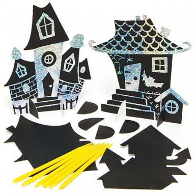 Two black scratch art haunted house cut-outs with glittery designs are displayed upright, perfect for Hallowe'en. In front, there are blank scratch art pieces, yellow styluses, and paper tabs for assembling the houses.