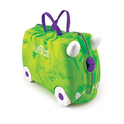 A green and yellow marbled children’s suitcase with white wheels, purple handles, and two white horn-like protrusions on the front. The suitcase has the word "Trunki" printed on the side, featuring a fun Trunkisaurus Rex design.