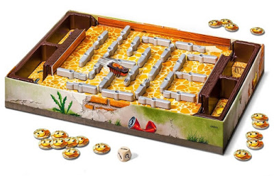 A board game featuring a maze with grey walls, a small plastic scorpion inspired by the bugs in the kitchen game, a wooden die, and several round tokens with smiling faces scattered around the desert-themed board.