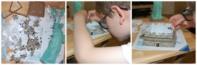 A child assembles a Ravensburger 3D puzzle of the Statue of Liberty, starting with scattered pieces, then fitting them together, and finally completing the upper section—a fun revision of how 3D puzzles come to life.