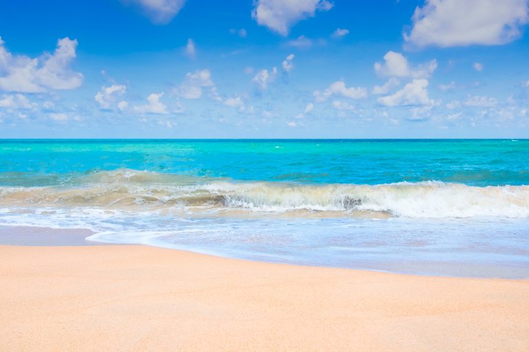 a beautiful sunny beach picture, golden sands and blue sea and sky