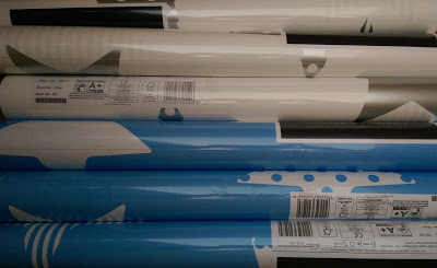 multiple rolls of blue and white starred wallpaper from Graham and Brown