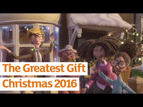 Four animated characters, three women and one man, stand smiling and waving outside a snow-covered house decorated with Christmas lights. Text reads: "The Greatest Gift Christmas 2016." Celebrate the magic of Christmas together.