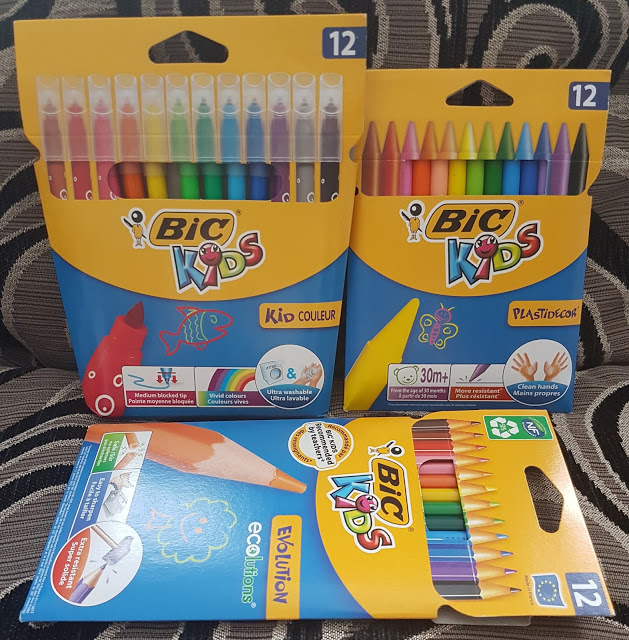 Three packs of BIC Kids coloured pens and pencils on a patterned surface. Get creative with BIC Kids—each pack contains 12 bright shades of felt-tip pens, coloured pencils, and eco-friendly coloured pencils.
