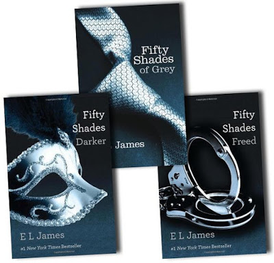 Three book covers from the "Fifty Shades" series by E.L. James—"Fifty Shades of Grey" with a tie, "Fifty Shades Darker" with a mask, and "Fifty Shades Freed" with handcuffs—perfect books to read whilst you're on holiday.