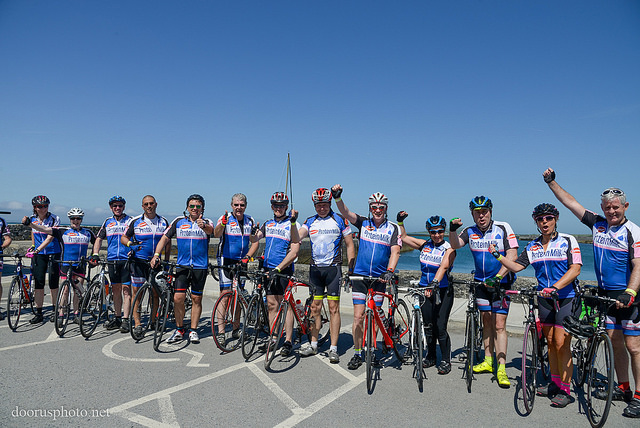Happy men posing with their adult cycling club