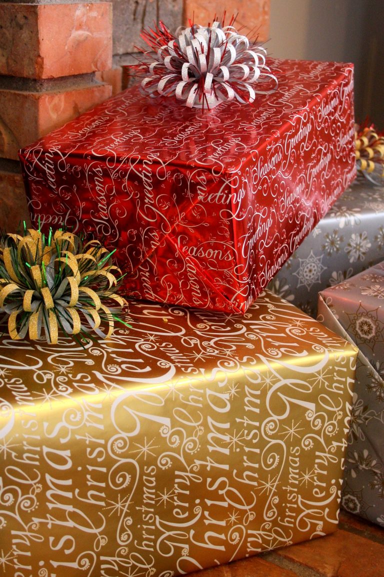 A Pile of Christmas Gifts in gold, red and silver wrapping paper